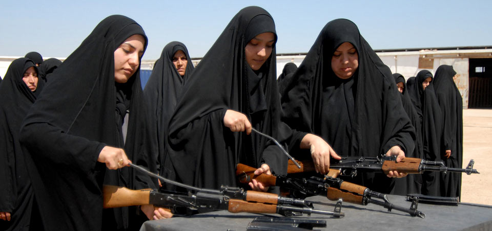 Iraqi female recruits disassemble AK-47 assault rifles during weapons training for recruits in basic training at the Iraqi Police Academy in Karbala